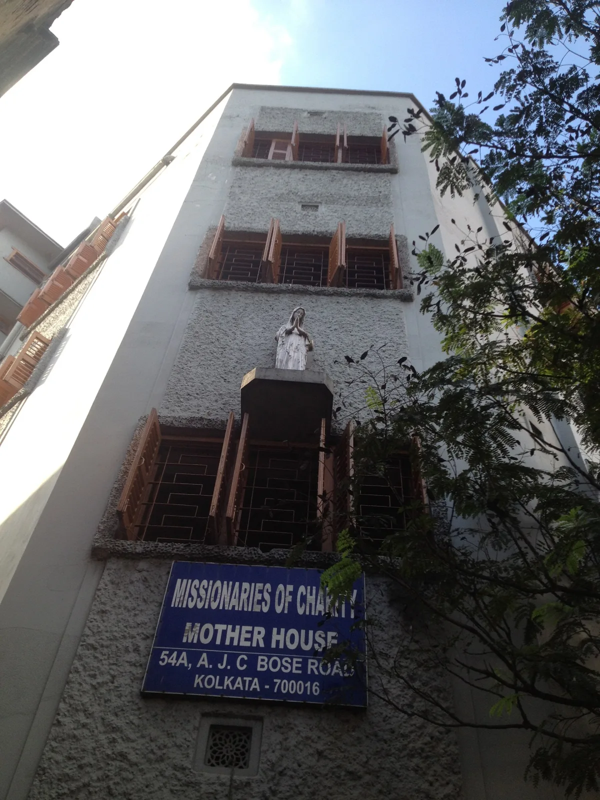 Red-brick exterior and entrance of the Missionaries of Charity Mother House in Kolkata.