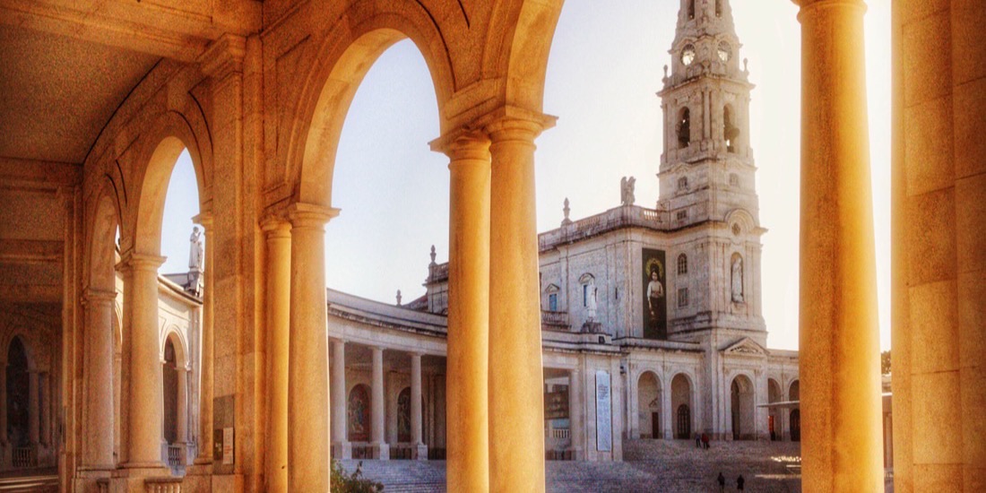 The colonnade of the Fátima sanctuary looking across the esplanade to the Basilica of Our Lady of the Rosary.