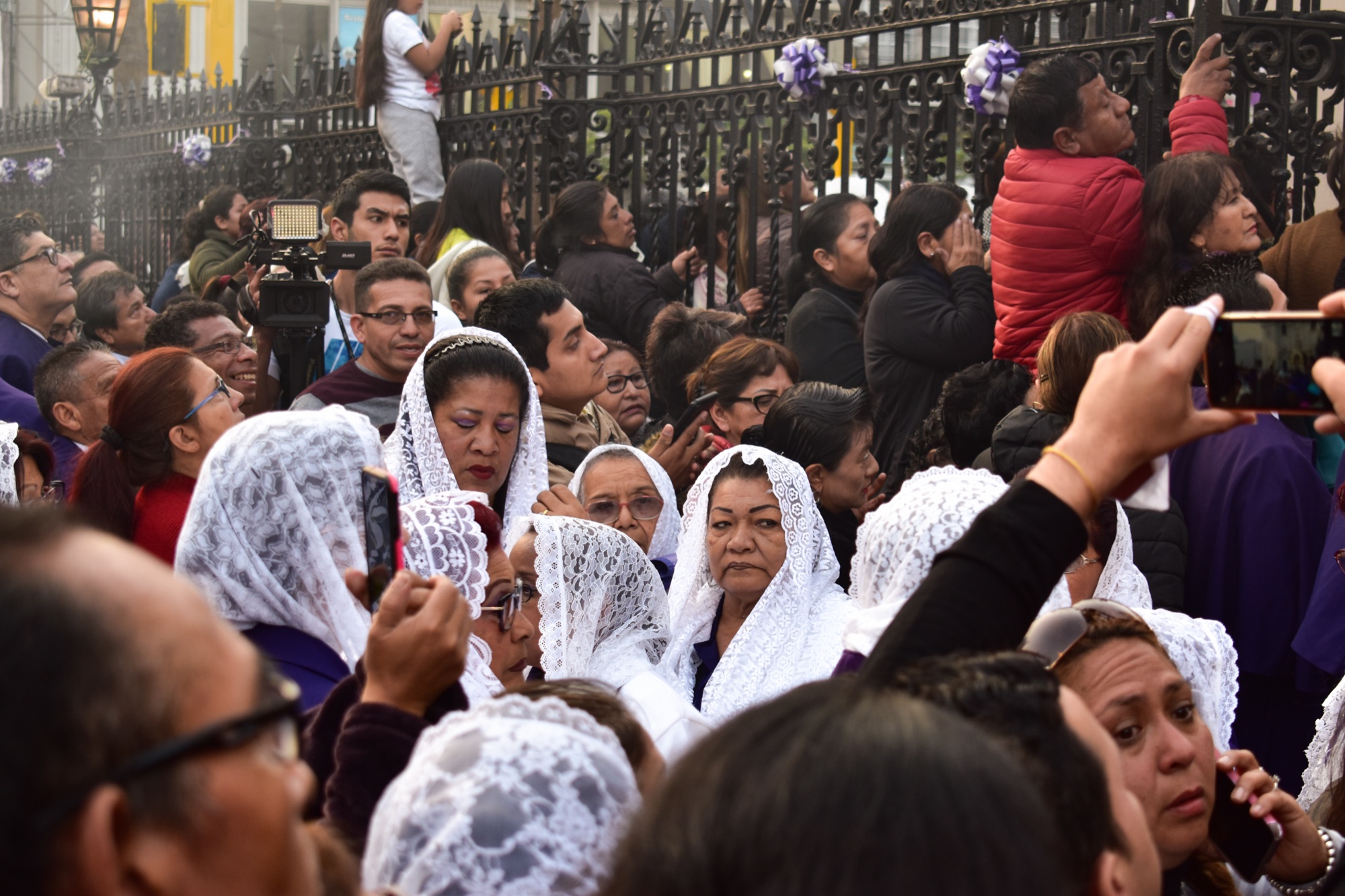 Women in the incense guild walking in the October procession of the Lord of Miracles in Lima.