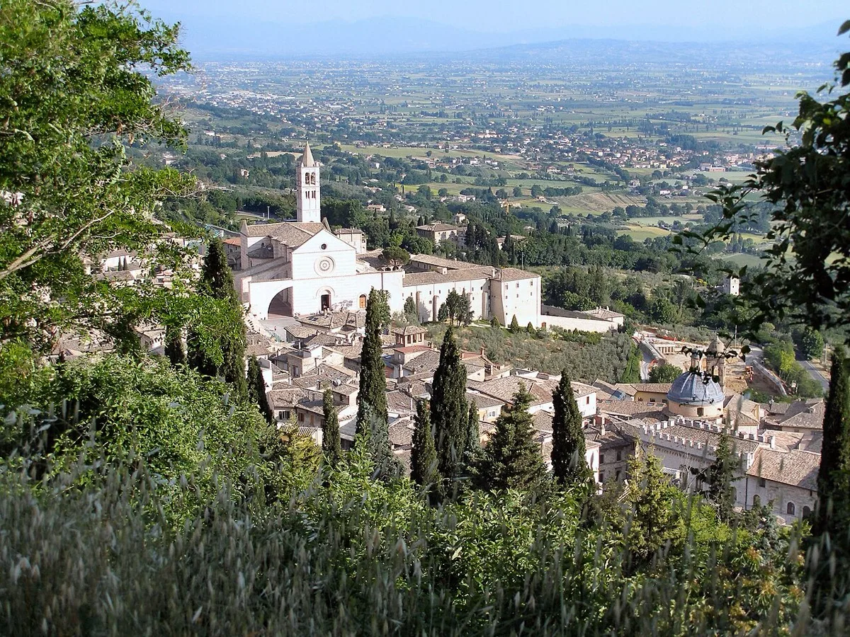 The striped stone facade of the Basilica of Saint Clare in Assisi.