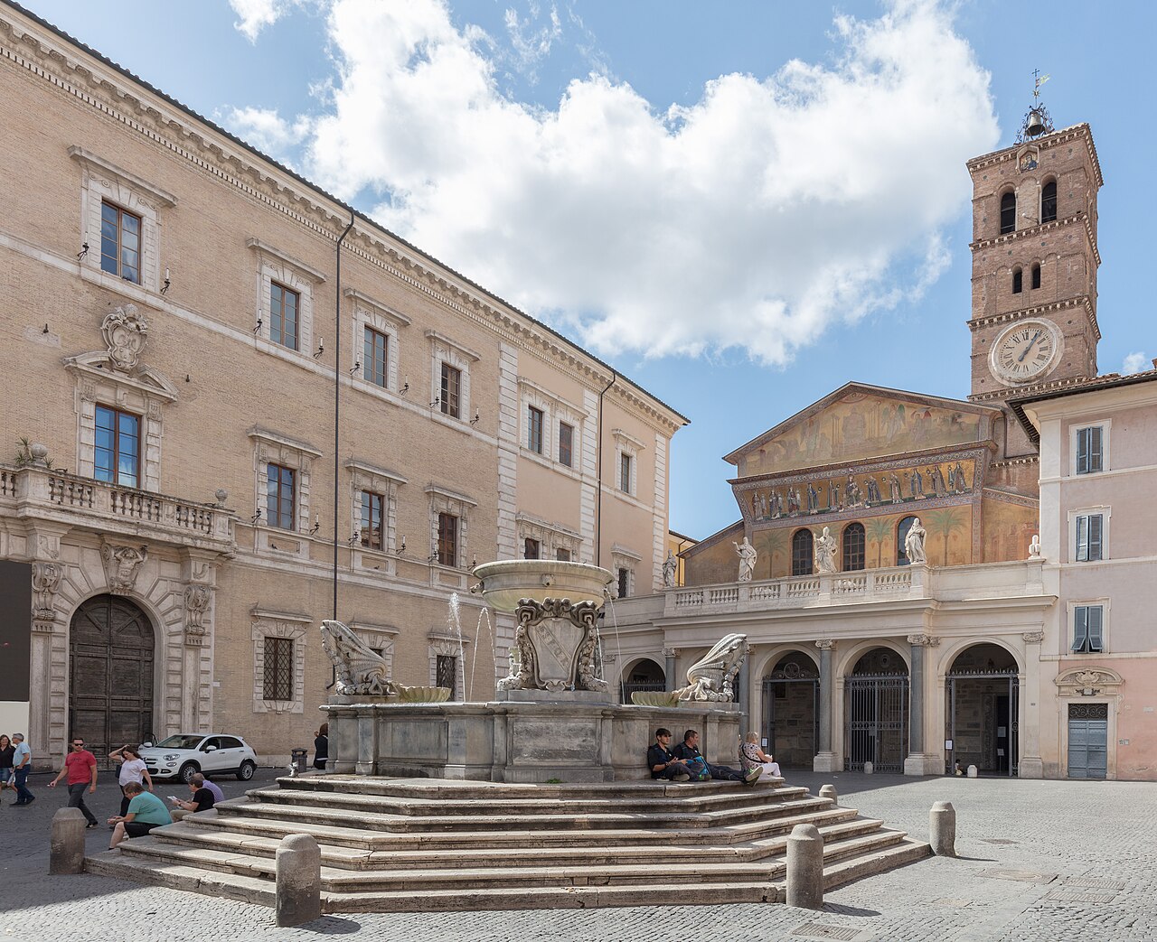 The mosaic facade and campanile of Santa Maria in Trastevere above the piazza fountain