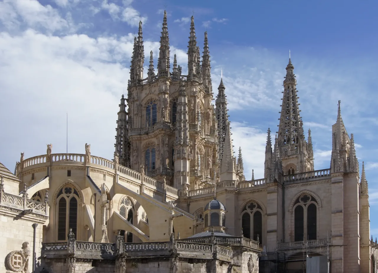 The east end of Burgos Cathedral against a blue sky: the pinnacled lantern over the crossing and, to the right, the spires of the Constable's Chapel.