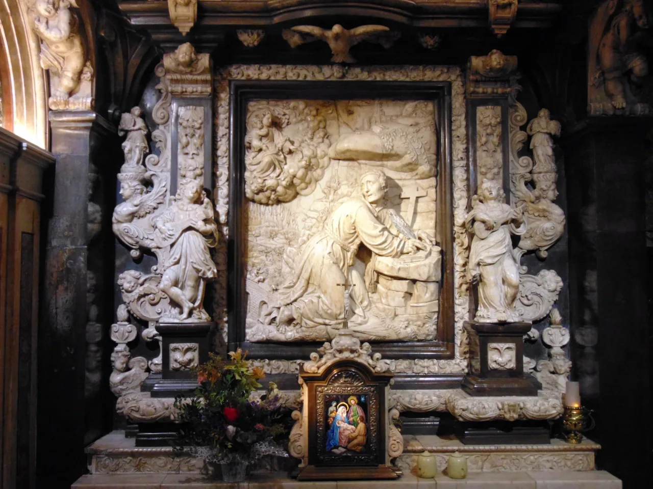The devotional chamber of the Cave of Saint Ignatius, with a carved relief of the saint praying before the Holy Trinity.