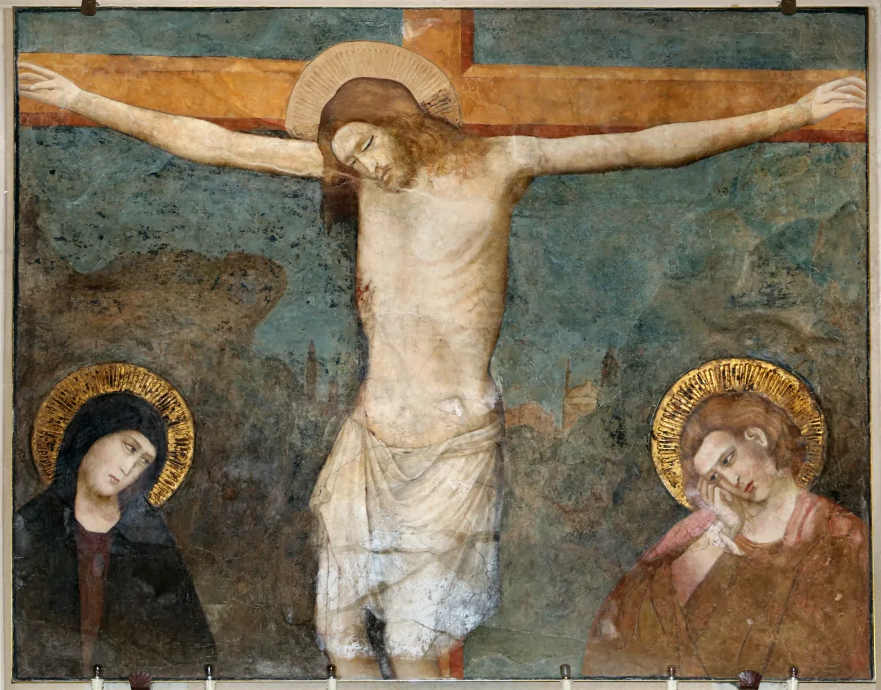 A fourteenth-century fresco of the Crucifixion, Christ on a red and gold cross between the mourning Virgin and Saint John against a blue-green ground.