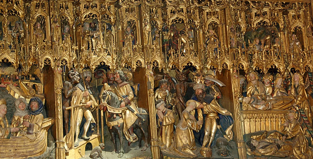 A detail of the gilded oak Dymphna retable at Geel, carved with the flight by boat, the king on horseback and the martyrdom.