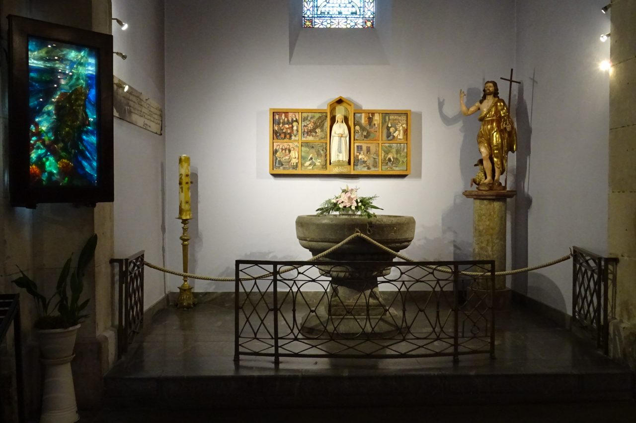 The stone baptismal font of Saint Bernadette in the Parish Church of the Sacred Heart in Lourdes.