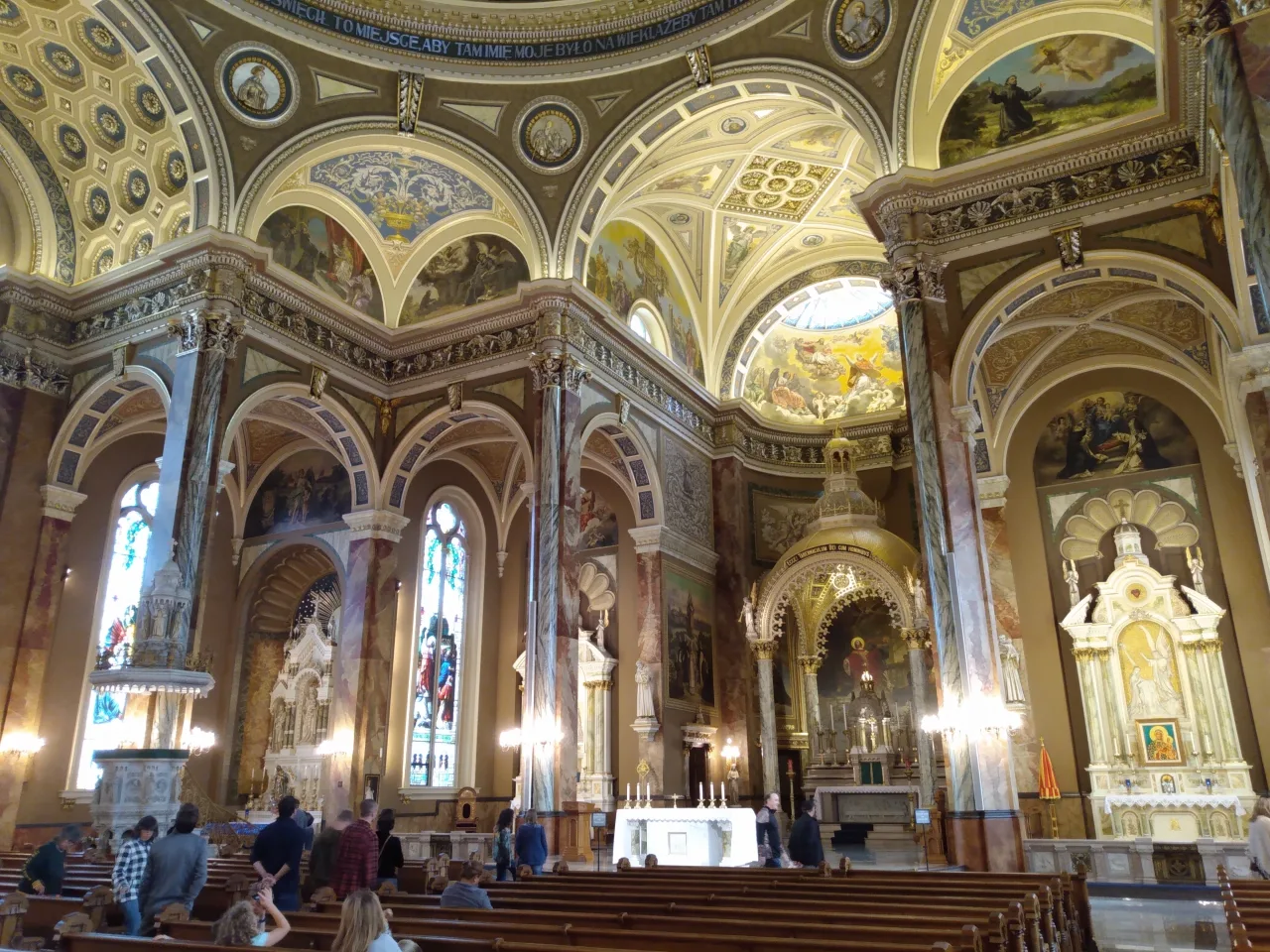 The richly painted nave, dome, sanctuary, and side altars inside the Basilica of Saint Josaphat in Milwaukee.