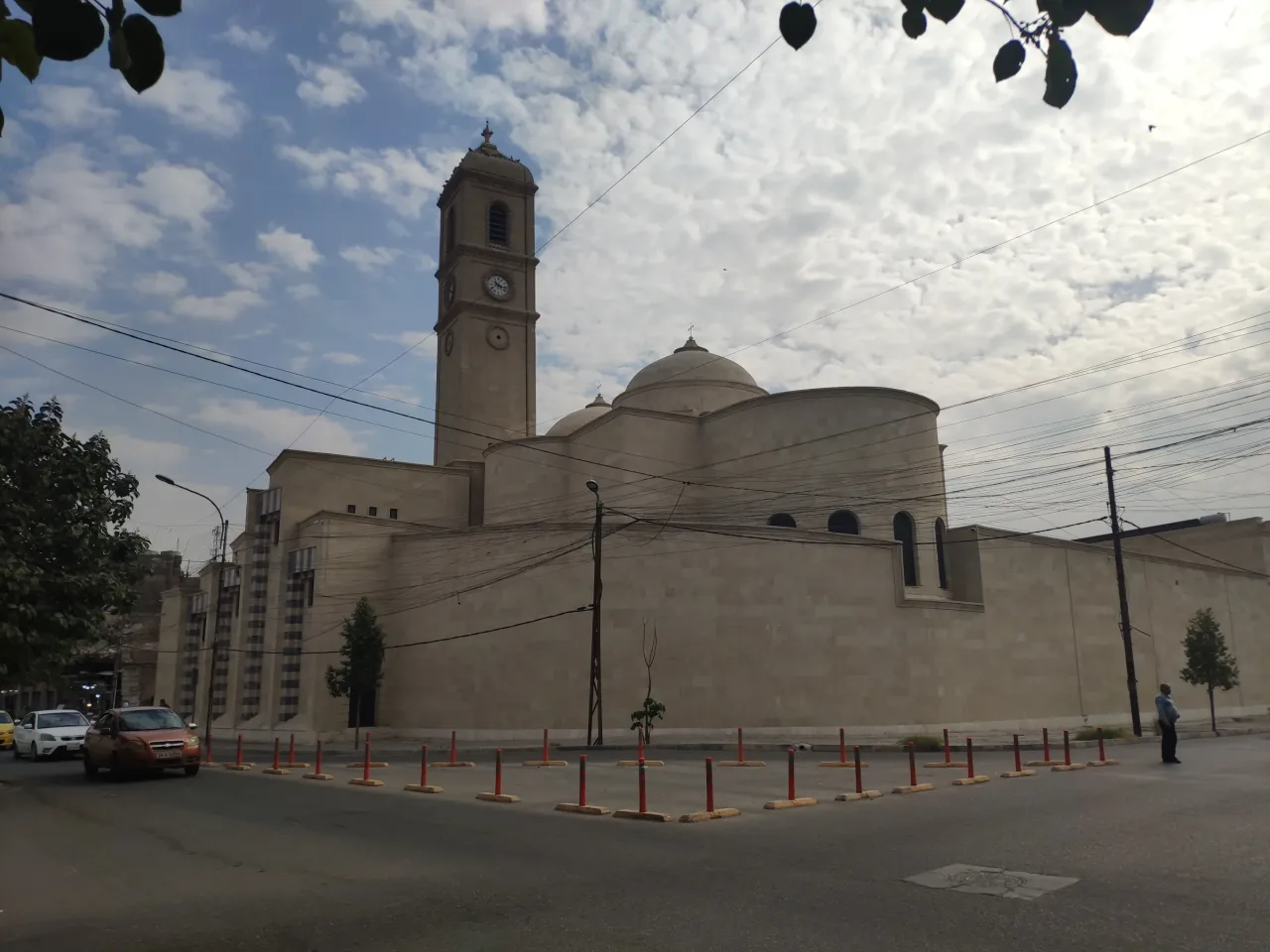 Exterior of Our Lady of the Hour Dominican Church in the Old City of Mosul, showing the restored clock tower and dome.