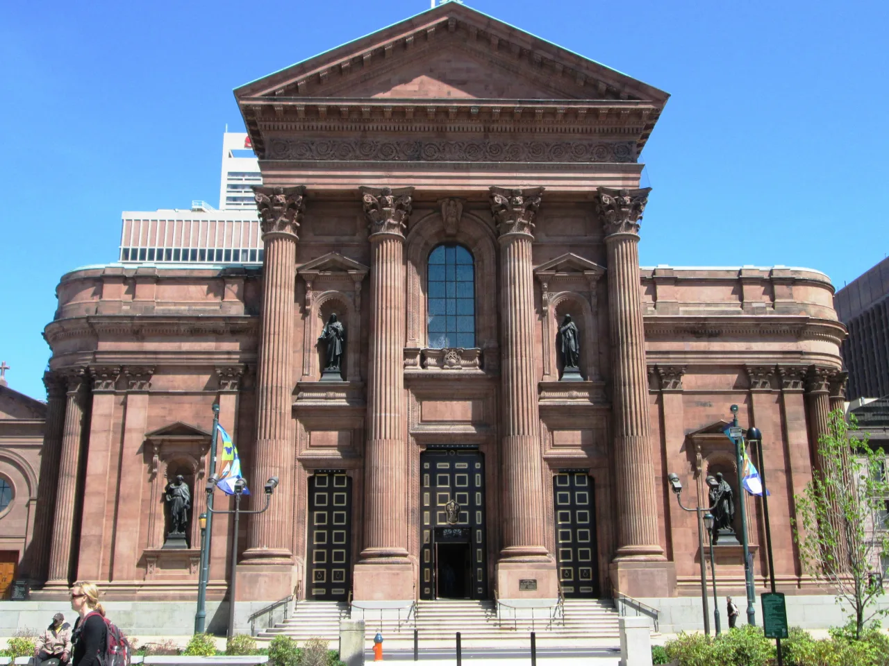 The brownstone facade of the Cathedral Basilica of Saints Peter and Paul in Philadelphia, with its Corinthian portico and great dome.
