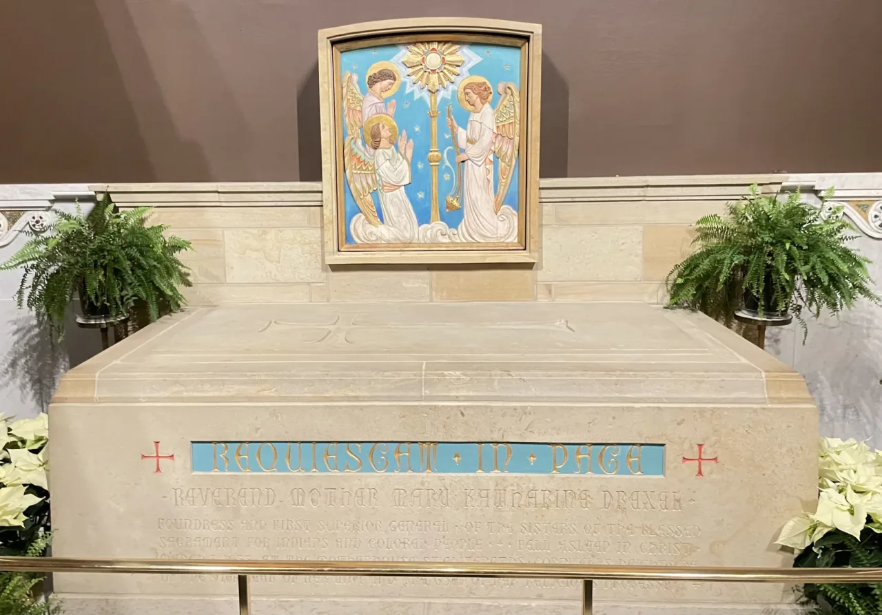 The tomb of Saint Katharine Drexel in the Philadelphia cathedral, set beneath a mosaic of the saint with kneeling angels.