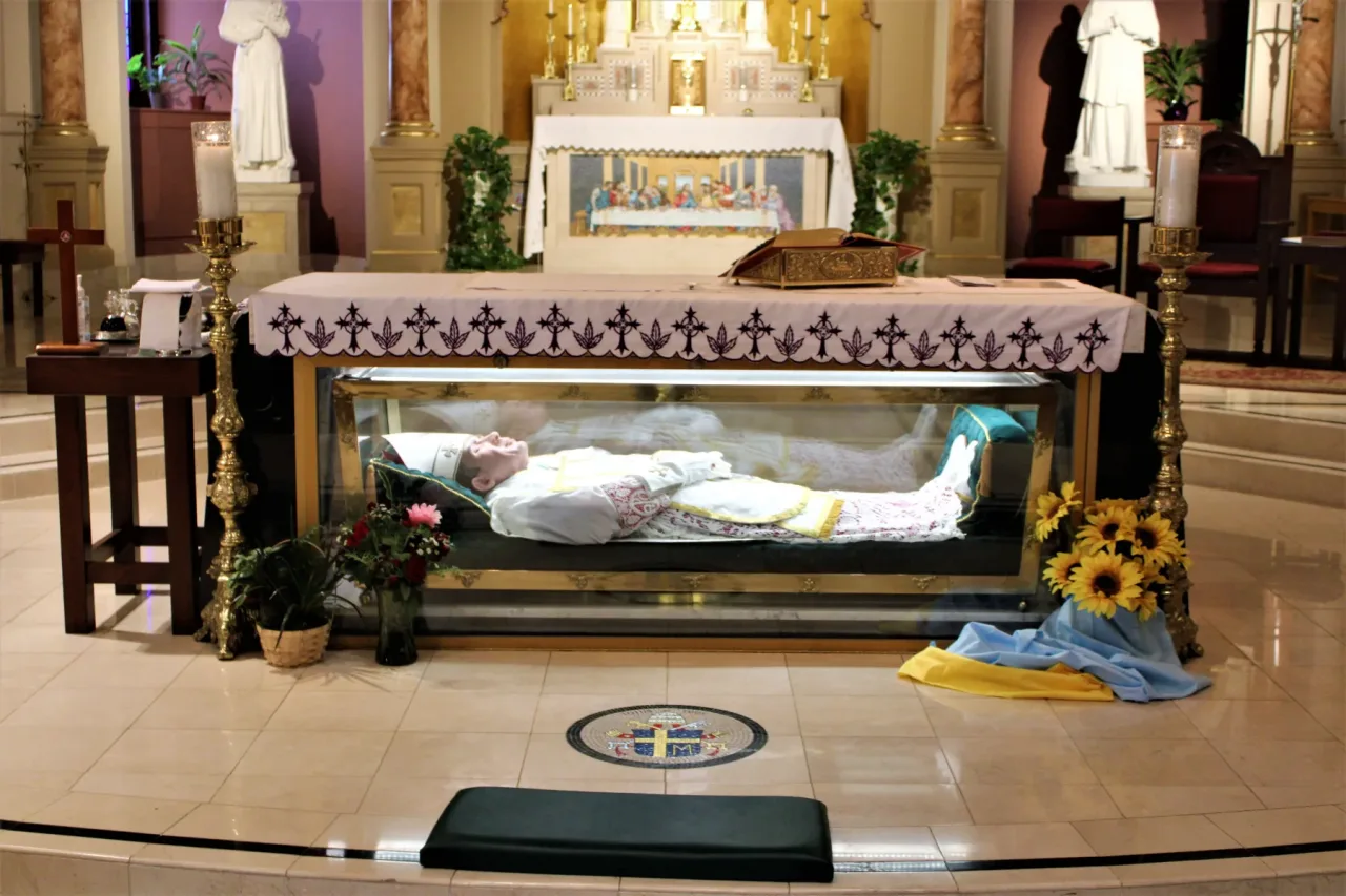 The glass tomb of Saint John Neumann beneath the lower shrine altar, showing the saint vested as a bishop.