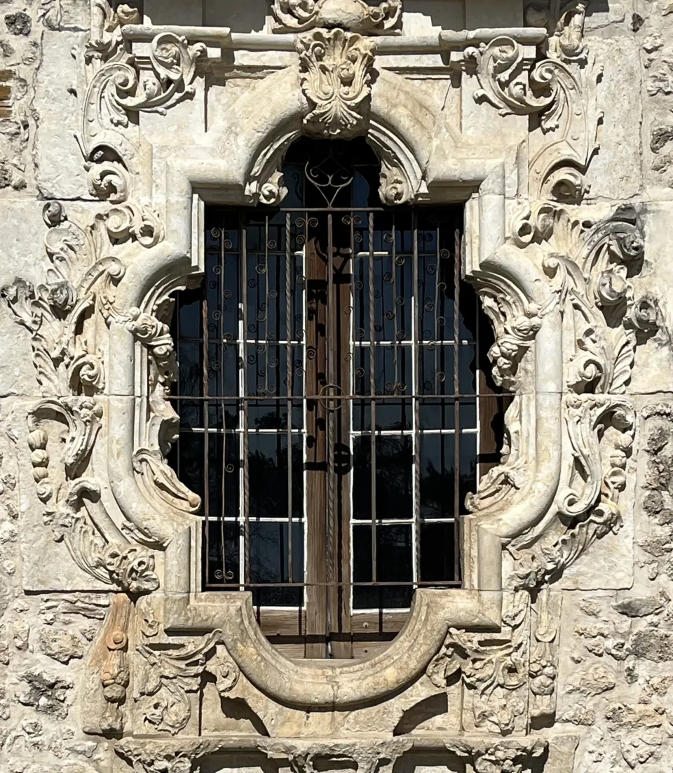 The carved limestone rose window on the south wall of Mission San José in San Antonio.