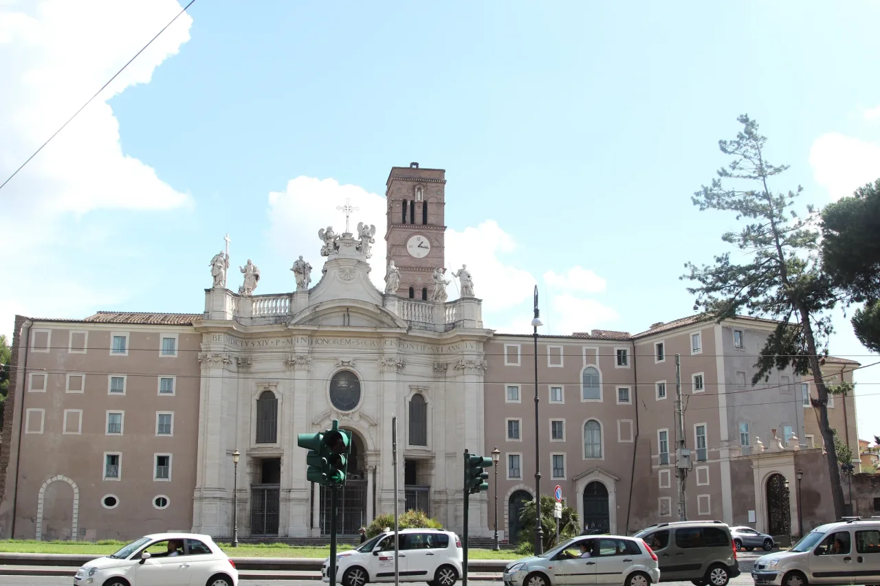 The facade and bell tower of Santa Croce in Gerusalemme, Rome, seen across its square.