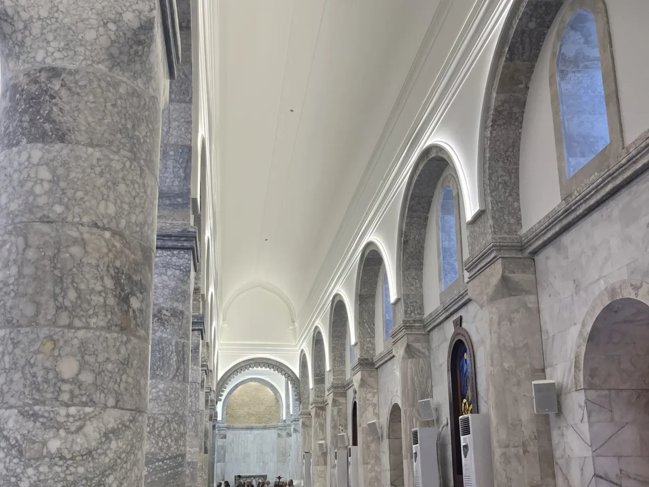 Interior of St. Mary Al-Tahira in Qaraqosh (Baghdeda), looking down the nave arcade toward the sanctuary dome.