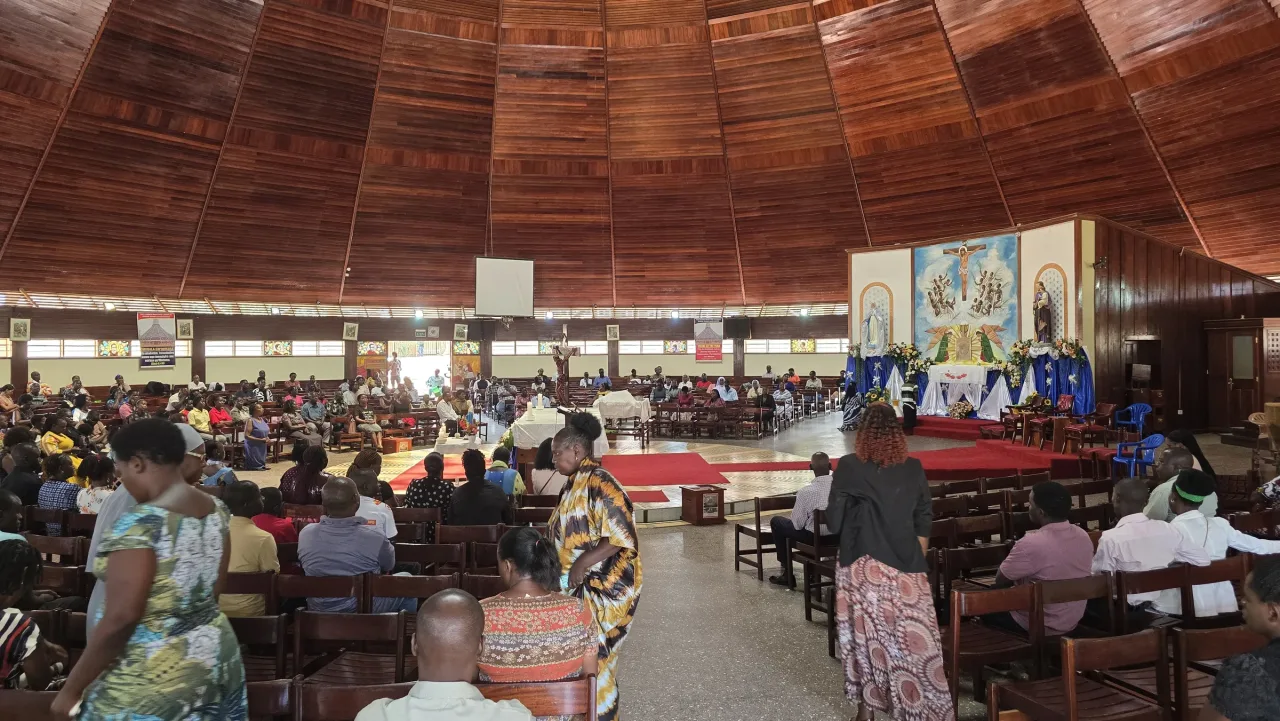 The circular timber interior of the Uganda Martyrs Basilica at Namugongo during Mass.