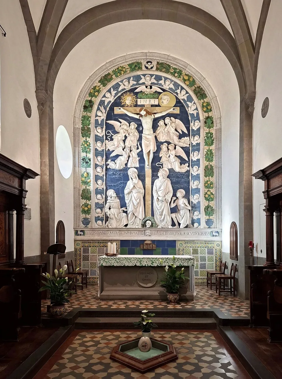 The Chapel of the Stigmata at La Verna: Andrea della Robbia's blue and white glazed terracotta Crucifixion above the altar, with a marked place in the patterned floor.