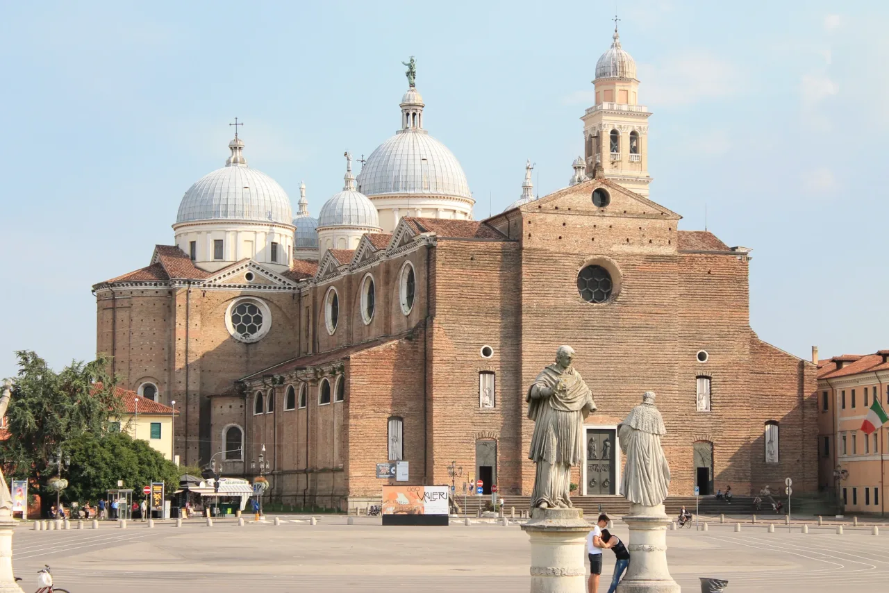 The domes and brick facade of the Basilica of Santa Giustina in Padua.