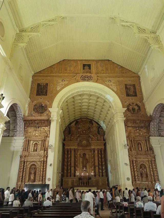 The nave and principal altar of Bom Jesus with pilgrims on Saint Francis Xavier’s feast, December 3, 2025.