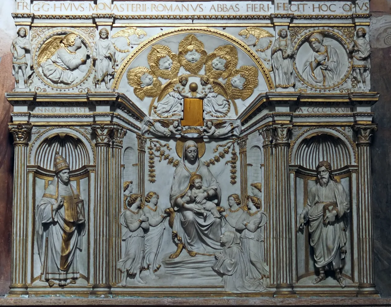 A white marble altarpiece picked out in gold: the Virgin and Child enthroned among angels, Saint Gregory in the papal tiara in the left niche, and a bearded saint in the right.