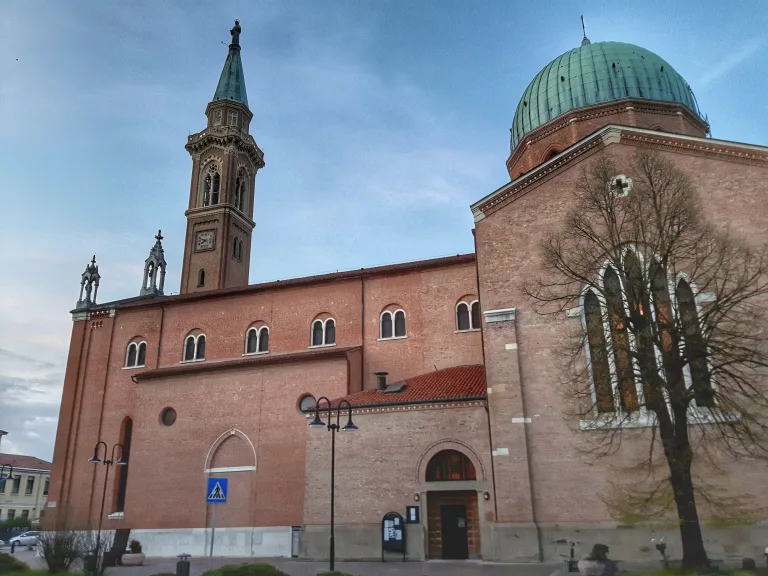 The red and white Arcella sanctuary with its dome and bell tower in northern Padua.