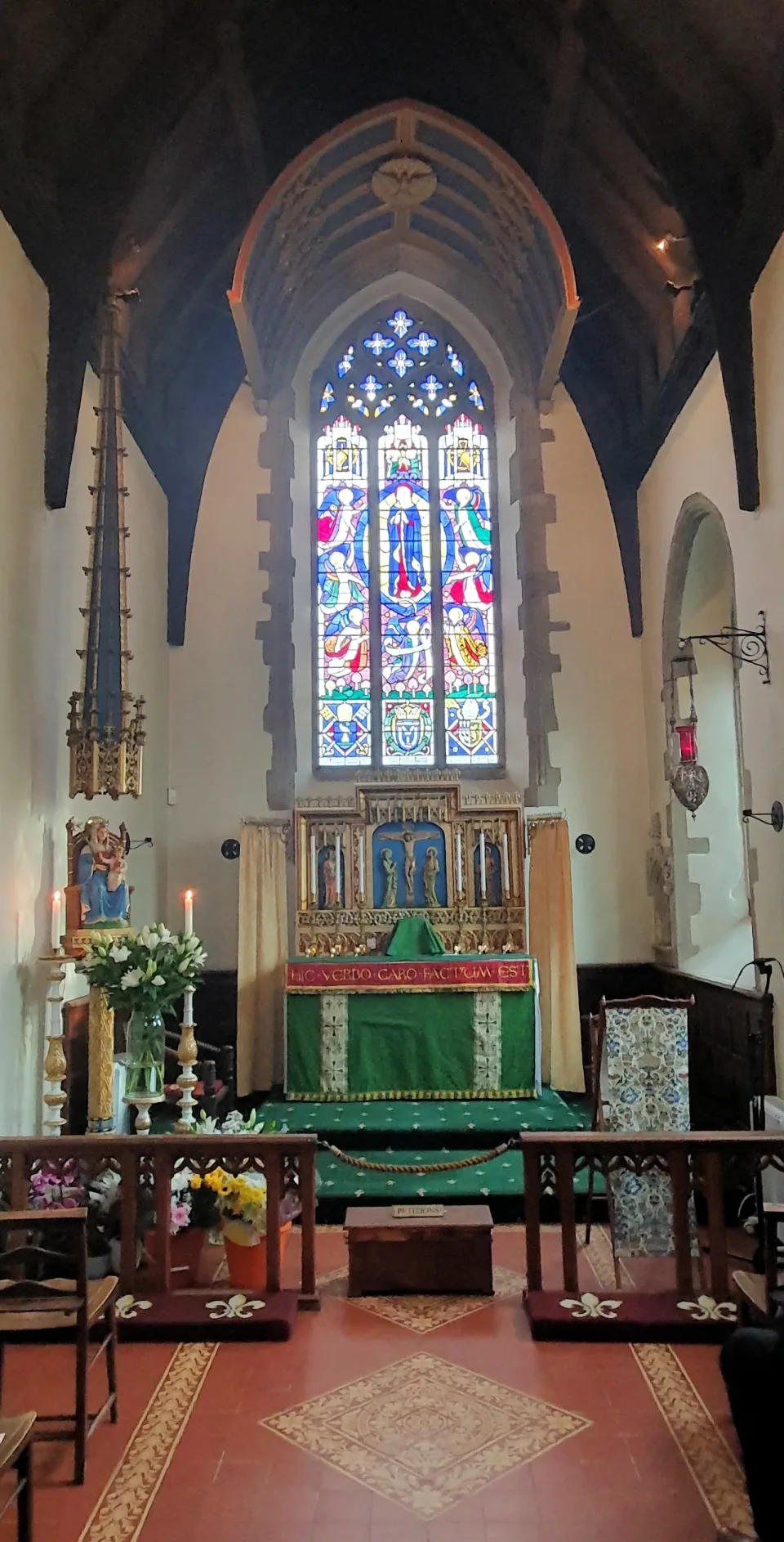 The altar, statue of Our Lady of Walsingham, and east window inside the Catholic Slipper Chapel.