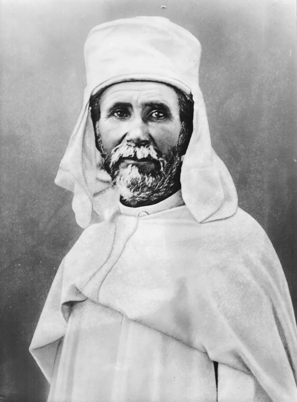 Photograph of Charles de Foucauld in the white gandoura and headcloth he wore in the Sahara.